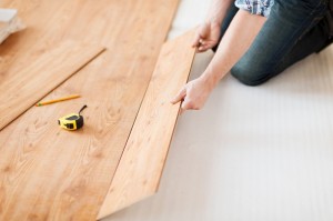 close-up-of-male-hands-intalling-wood-flooring